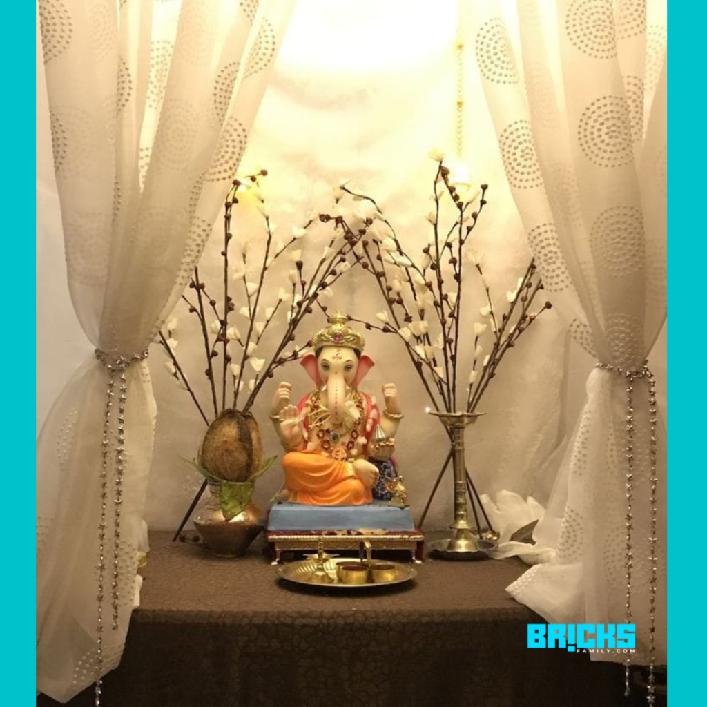 Ganapati flower decoration with drapes in the background