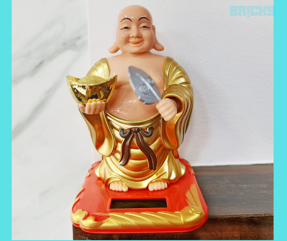 Laughing Buddha with fan for good luck