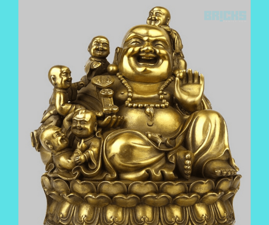 A laughing buddha figurine with five children