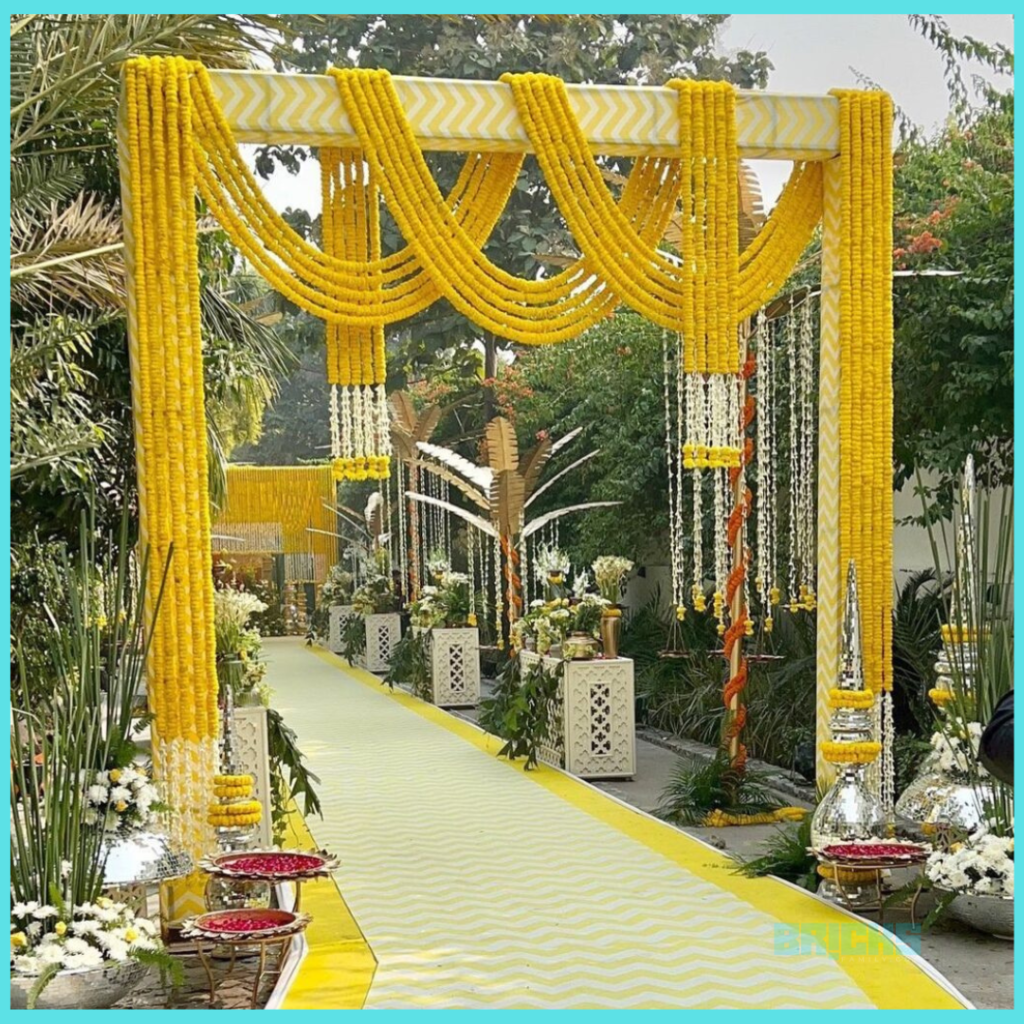 A chic and minimalistic haldi decoration at the entrance to the venue.