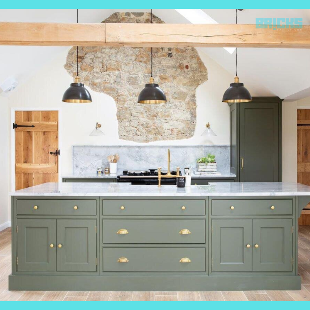 A cozy looking kitchen with muted green cabinets and lampshades as per feng shui kitchen rules