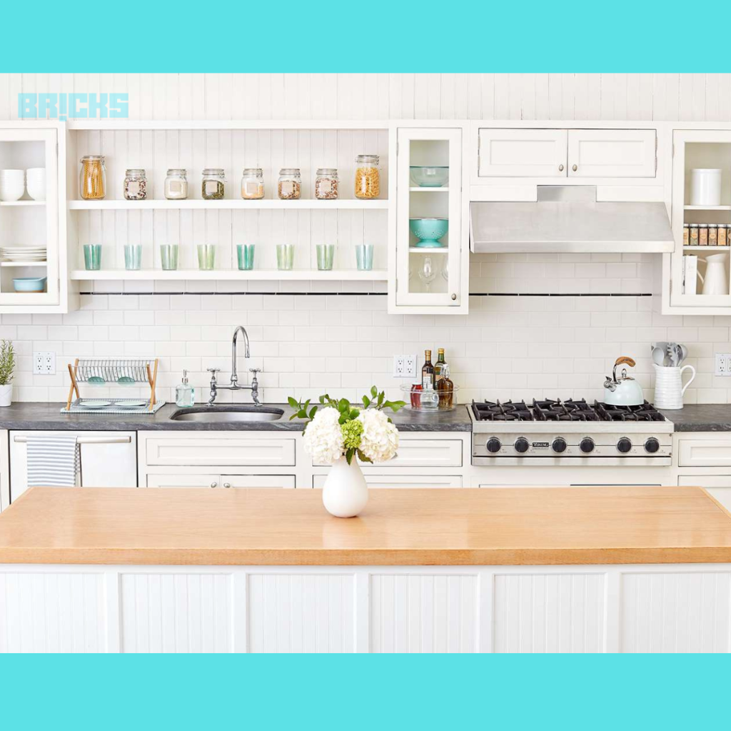 White interiors in a kitchen with transparent glass cabinets that could double as food or crockery storage.