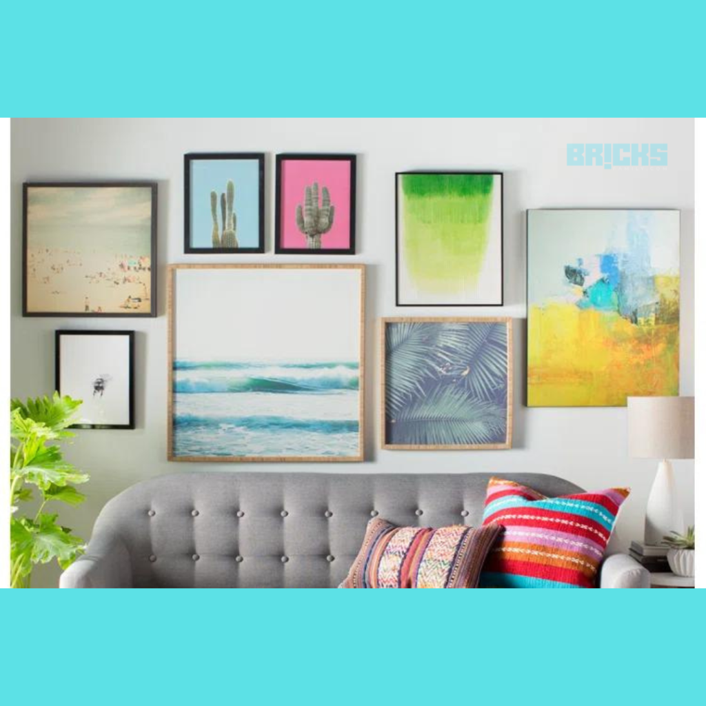 A poster wall with different kinds of artwork that add vibrancy add charm to a space